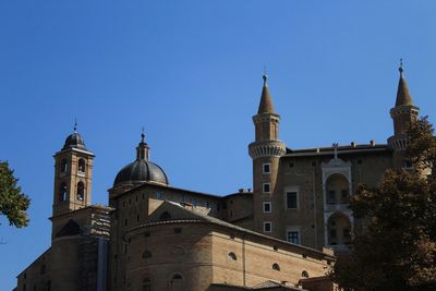 Low angle view of historic building against clear blue sky