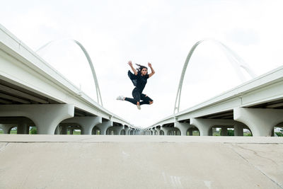 Man skateboarding on skateboard against sky
