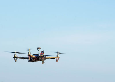 Quadcopter flying in clear blue sky