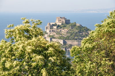 High angle view of buildings by sea against sky