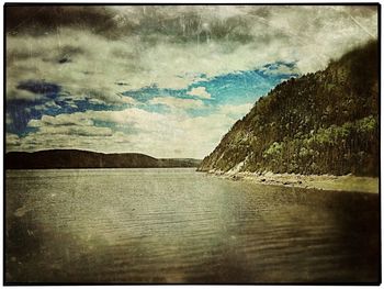 Scenic view of sea against cloudy sky