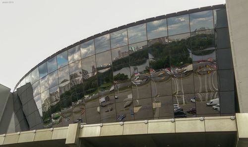 Low angle view of glass building against sky