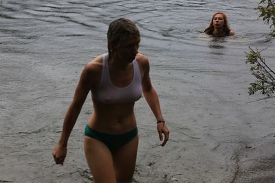 Portrait of young woman standing on beach