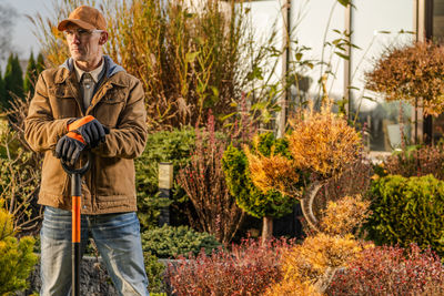 Rear view of man standing in farm