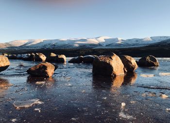 Scenic view of rocks against sky during winter