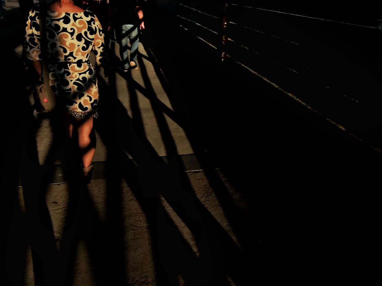 LOW SECTION OF WOMAN STANDING ON TILED FLOOR