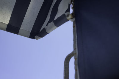 Low angle view of metallic structure against clear blue sky