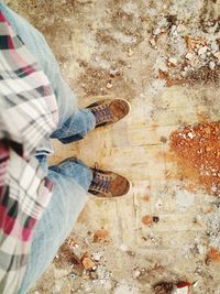 Low section of woman standing on ground