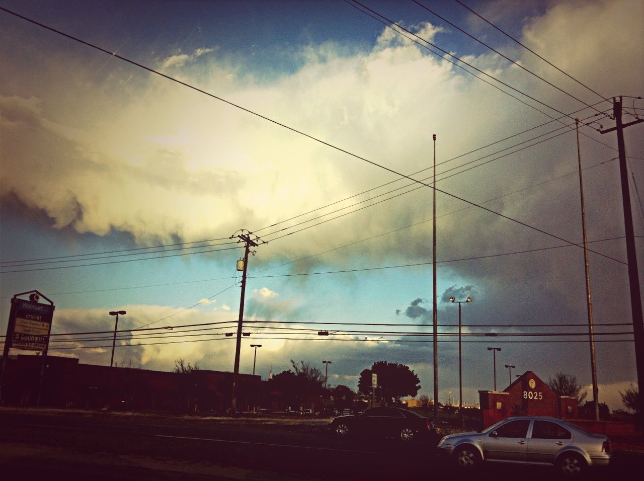 transportation, sky, land vehicle, car, mode of transport, power line, cloud - sky, electricity pylon, cloud, cable, cloudy, road, street, silhouette, power supply, street light, low angle view, electricity, connection, built structure