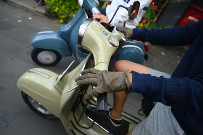 Midsection of man holding car