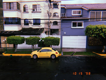 Cars on road by buildings in city