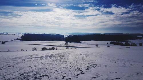 Scenic view of snow covered landscape against sky