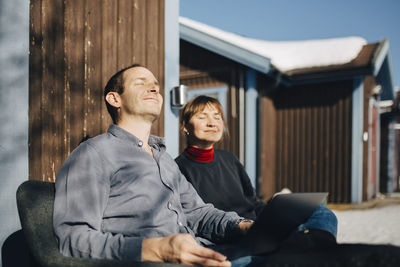 Young couple sitting on wall