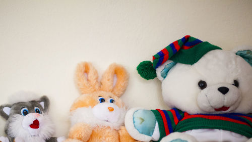 Close-up of stuffed toys against wall