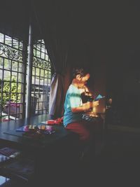 Woman working on table at home