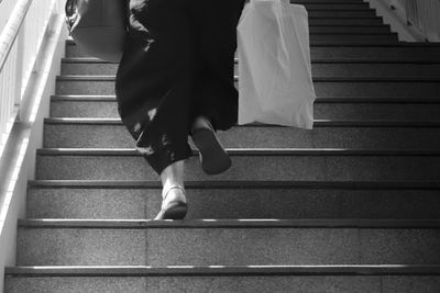 Low section of people walking on staircase