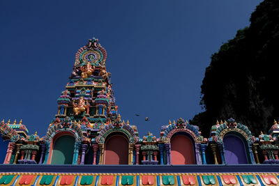 Low angle view of temple building against clear blue sky