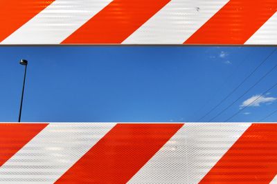 Low angle view of sky seen through street barrier