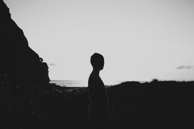 Silhouette woman standing on landscape against clear sky