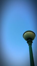 Low angle view of street light against clear blue sky