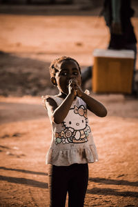 Full length portrait of girl standing outdoors