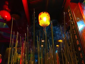 Low angle view of illuminated lanterns hanging at night