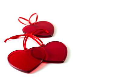 Close-up of red heart shape over white background