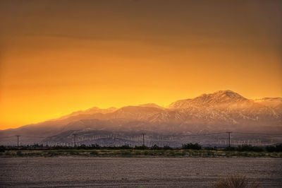 Scenic view of field against sky during sunset