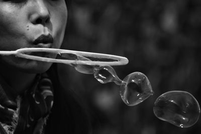 Close-up of woman blowing bubbles