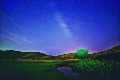 Scenic view of landscape against sky at night