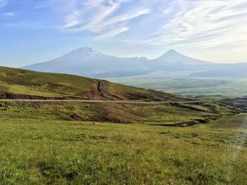 Scenic view of landscape and mountains against sky