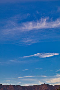 Low angle view of mountain against cloudy sky