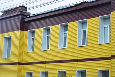 Low angle view of multi colored building against clear sky