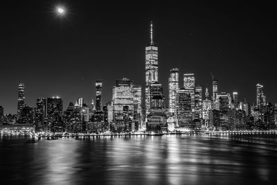 Illuminated buildings against sky at night