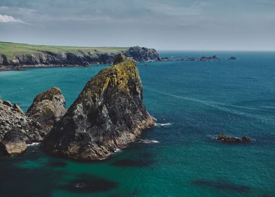 Scenic view of sea against sky at kynance cove in cornwall, england