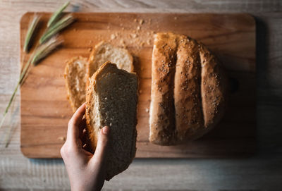 Midsection of man holding ice cream on table