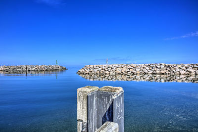 Scenic view of sea against clear blue sky