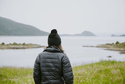 Rear view of woman looking at sea against sky