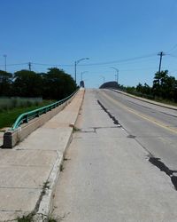Railroad tracks against blue sky