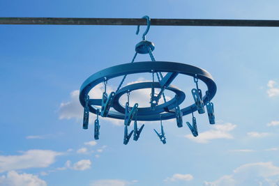 Low angle view of electric lamp against sky