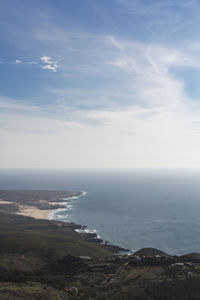 High angle view of coastline, with beach, ocean, blue sky and horizon