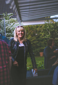 Smiling woman with friends in yard