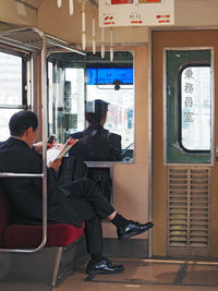 Rear view of men in tram