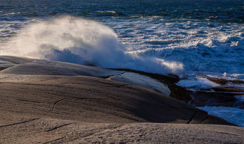 Waves splashing on rocks at shore