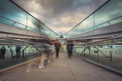 Blurred motion of people on london millennium footbridge in city