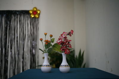 Close-up of flower vase on table at home