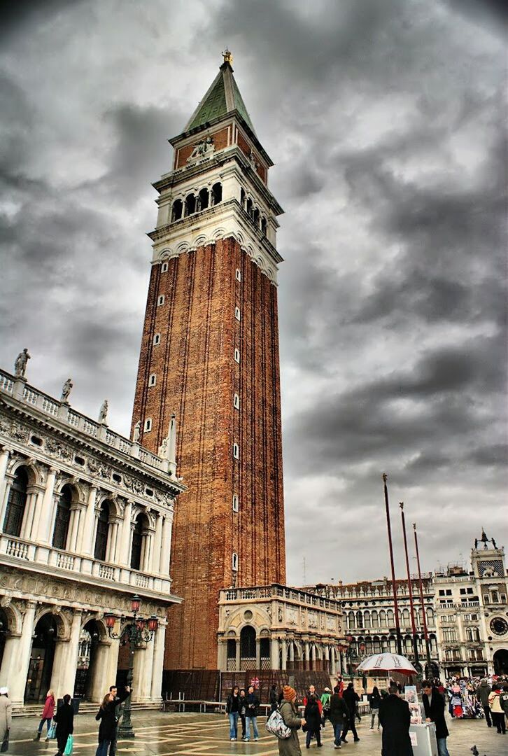 architecture, built structure, building exterior, famous place, sky, tourism, large group of people, travel destinations, cloud - sky, history, person, men, tourist, international landmark, travel, lifestyles, capital cities, cloudy, tower