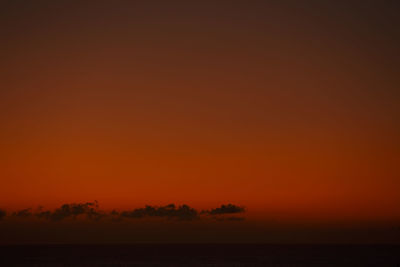 Scenic view of sea against romantic sky at sunset