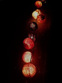 Close-up of illuminated lighting equipment against black background