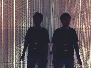 Men standing against wall